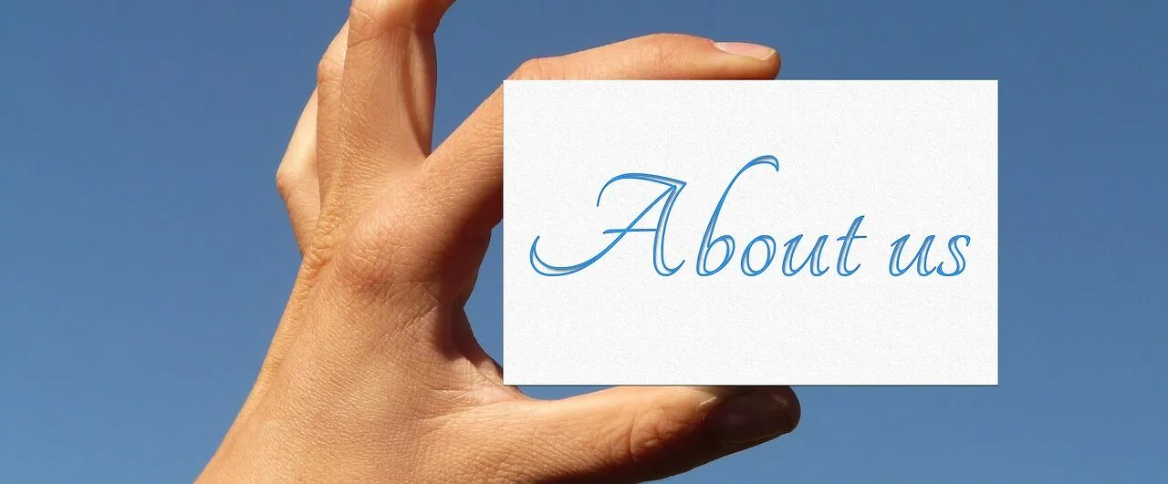 About us section with hand holding card